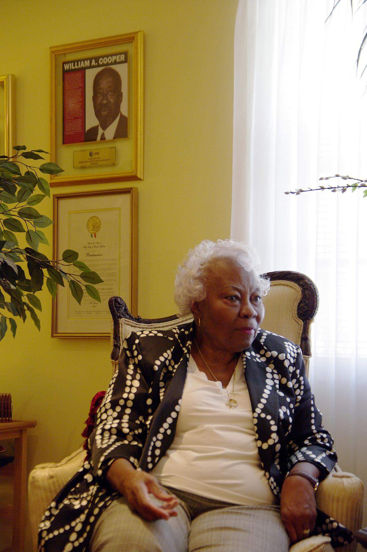 Leona Cooper is seen at her home in March 2010, with a picture of her husband William A. Cooper, who was active in the community. A park was named in his honor in Coral Gables.  