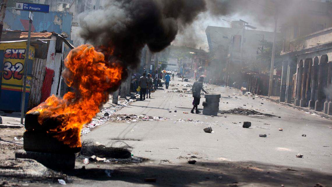 Tires burn at a roadblock set up by anti-government protesters downtown during a general strike in Port-au-Prince, Haiti, on July 9, 2018, part of a protest against a dramatic hike in fuel costs.