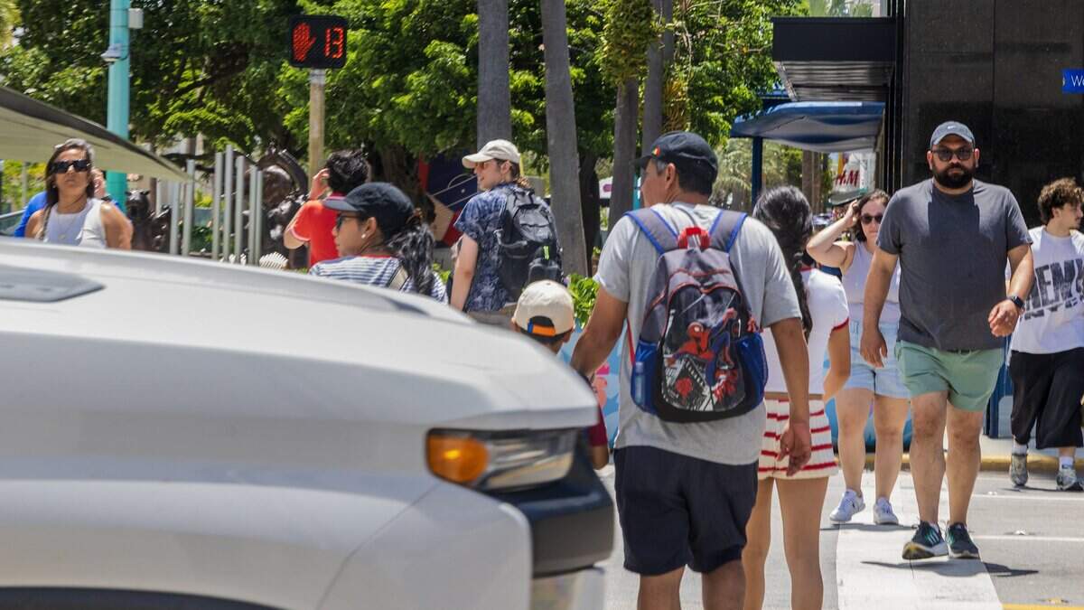 A truck passes as pedestrians crosses the street intersection at Lincoln Road and Washington Avenue, a hotspot where pedestrians get hit and seriously injured or killed, on Thursday June 11, 2026.