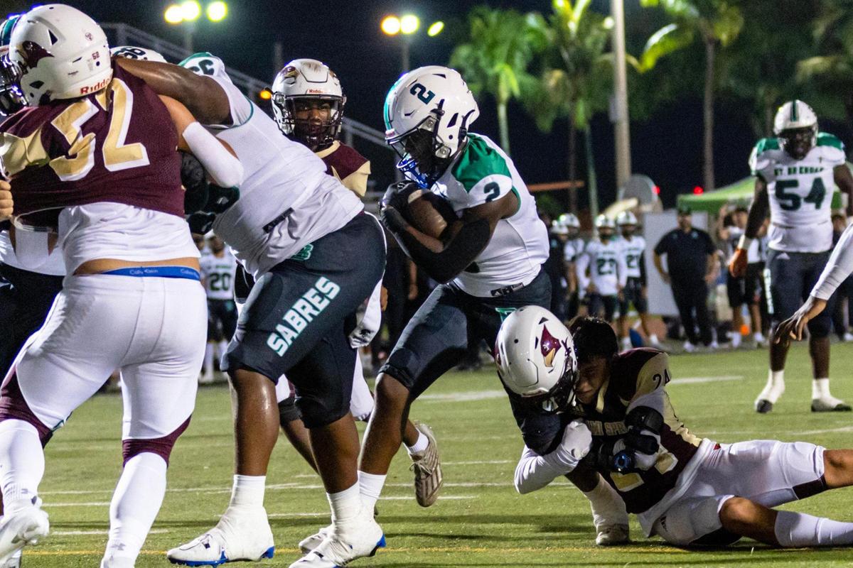 Saint Brendan defensive back Widley Jean-Francois (2) runs the ball as Miami Springs running back Samuel Rodriquez (24) attempts to bring him down during a high school football game in Miami, Florida, on Friday, September 29, 2023.
