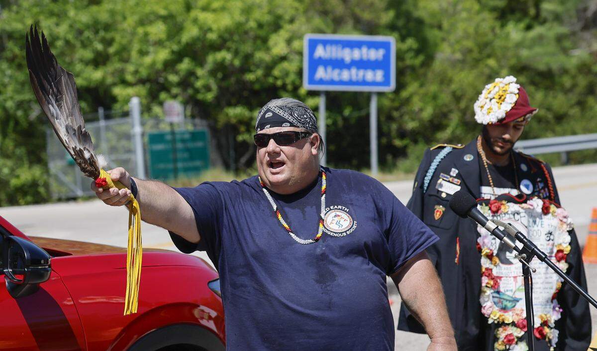 Gary Wilcox, a Native American Indian, opens the May Day Rally with the traditional Four Directions song welcoming protestors outside of Alligator Alcatraz located at the Dade-Collier Training and Transition Airport in the Florida Everglades, Ochopee, Florida, on Friday, May 1, 2026.