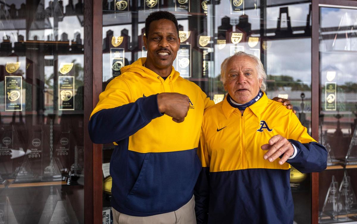 Fort Lauderdale, Florida, June 2, 2021 - New Athletic Director, Twan Russell (left) kids around with retiring Athletic Director George Smith (right) during a photo shoot at St. Thomas Aquinas High School. George Smith, one of the most storied coaches in high school football history, is retiring at the end of the school year.