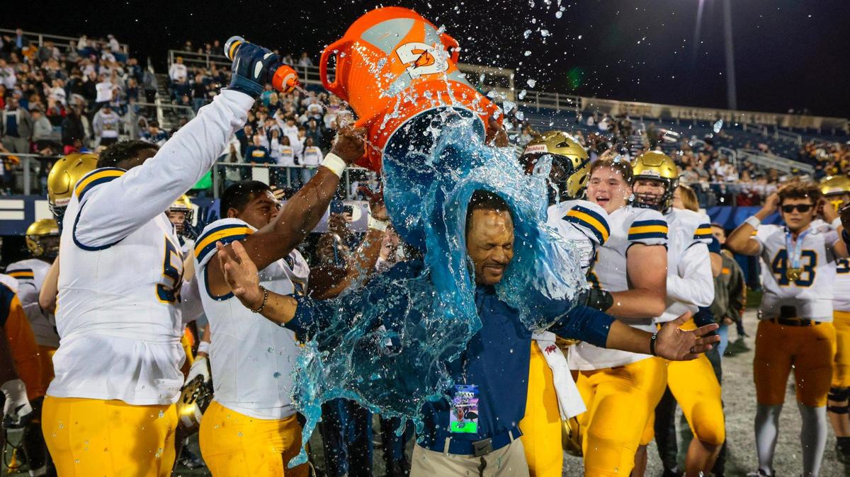 St. Thomas Aquinas head coach Roger Harriott doused with a bucket of Gatorade by players after Aquinas wins the game against Lakeland Dreadnaughts during the Florida High School Football State Championships - Class 5A game at Pitbull Stadium on the campus of Florida International University in Miami, Florida, on Thursday, December 12, 2024.