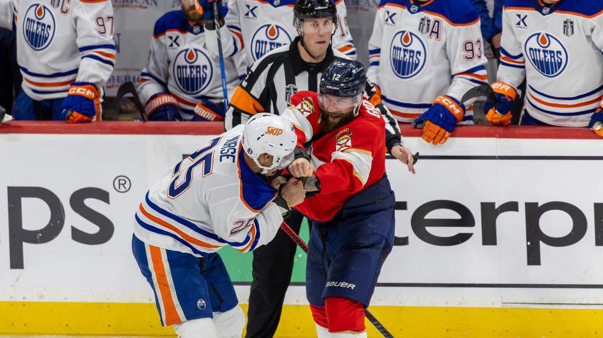 NHL referee Francis Charron (6) looks as Edmonton Oilers defenseman Darnell Nurse (25) and Florida Panthers left wing Jonah Gadjovich (12) fight during the third period of Game 3 in the Stanley Cup Final at Amerant Bank Arena on Monday, June 9, 2025, in Sunrise, Fla.