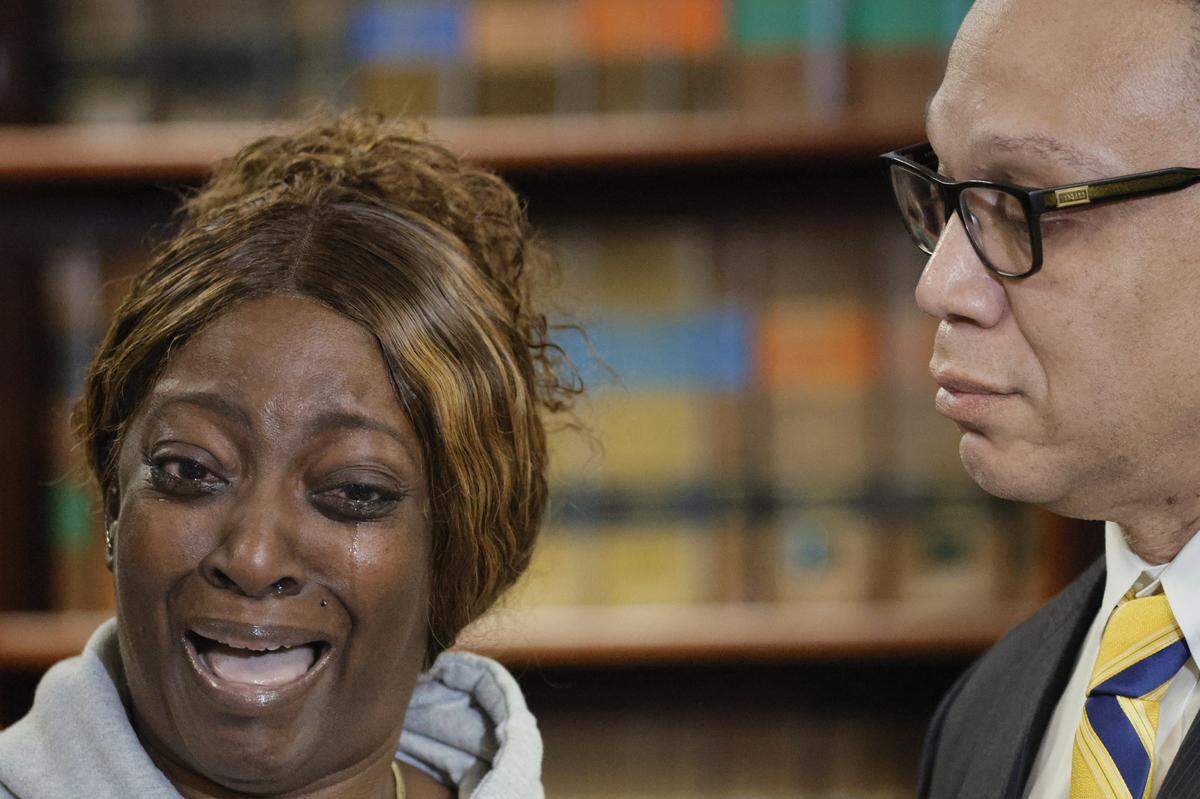 Corine Modeste, breaks down as she speaks about her brother during a news conference at the Broward Public Defender’s Office in Fort Lauderdale on Thursday, Feb. 1, 2024, while Broward Public Defender Gordon Weekes looks on at right. Alvin Stephen Modeste, 43, hanged himself in his cell at the North Broward Jail in Pompano Beach on Dec. 26, less than a month after a Broward judge ordered him to receive evaluation under the state’s Baker Act. According to Weekes, there have been 21 deaths in the jail since 2019. The NAACP has asked the Department of Justice to look into the incidents. (Amy Beth Bennett / South Florida Sun Sentinel)
