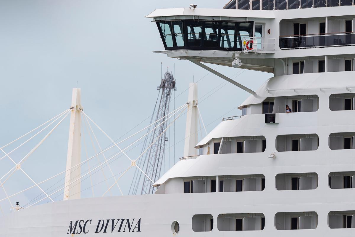 Crew members aboard MSC Divina can be seen as the ship is docked at PortMiami on Friday, May 15, 2020, in Miami, Florida.