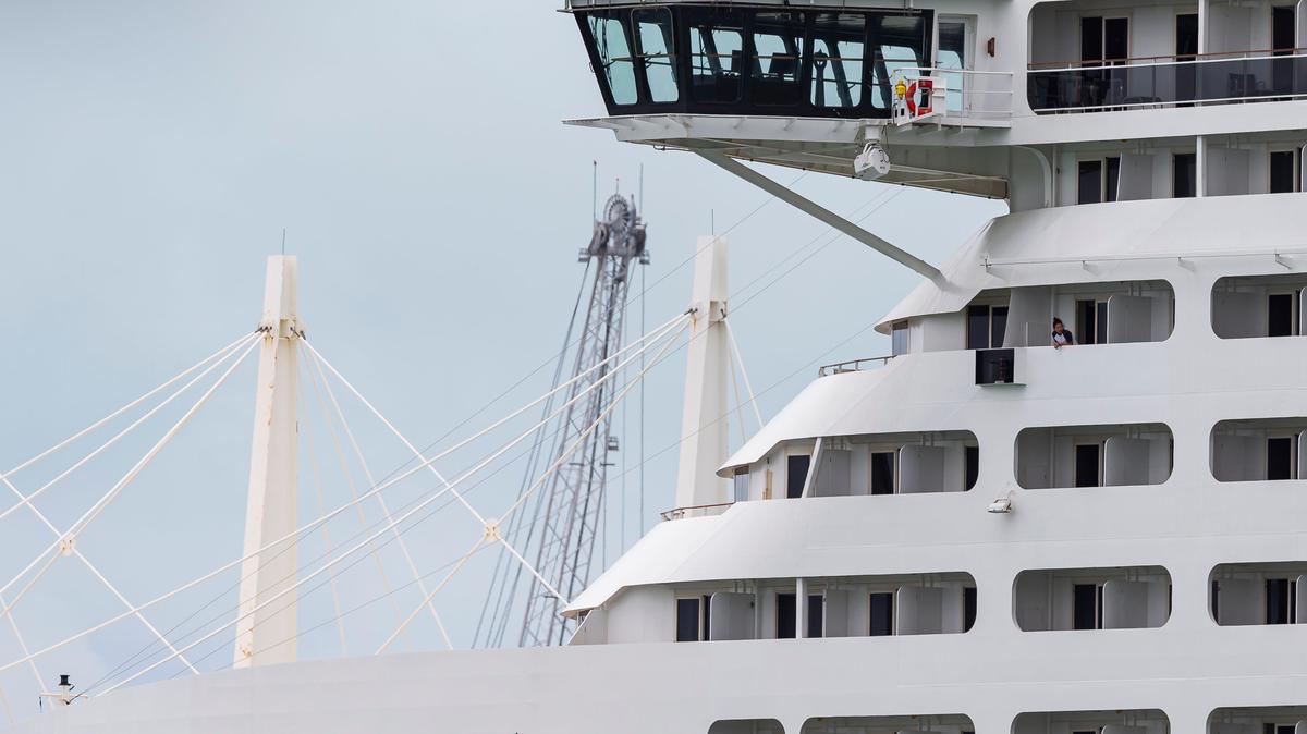 Crew members aboard MSC Divina can be seen as the ship is docked at PortMiami on Friday, May 15, 2020, in Miami, Florida.