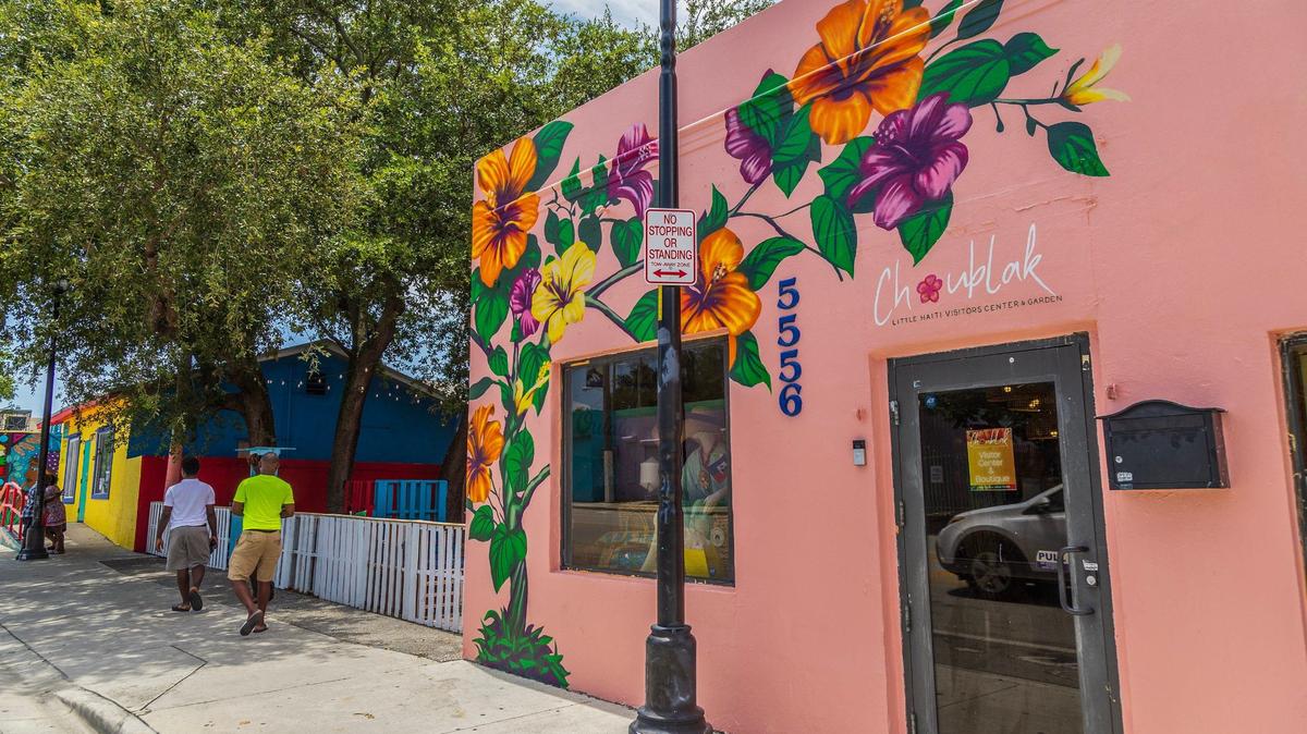 The exterior of the new Choublak Little Haiti Visitor Center and Garden displays a colorful mural of a flowering hibiscus vine by local artist James Brutus.