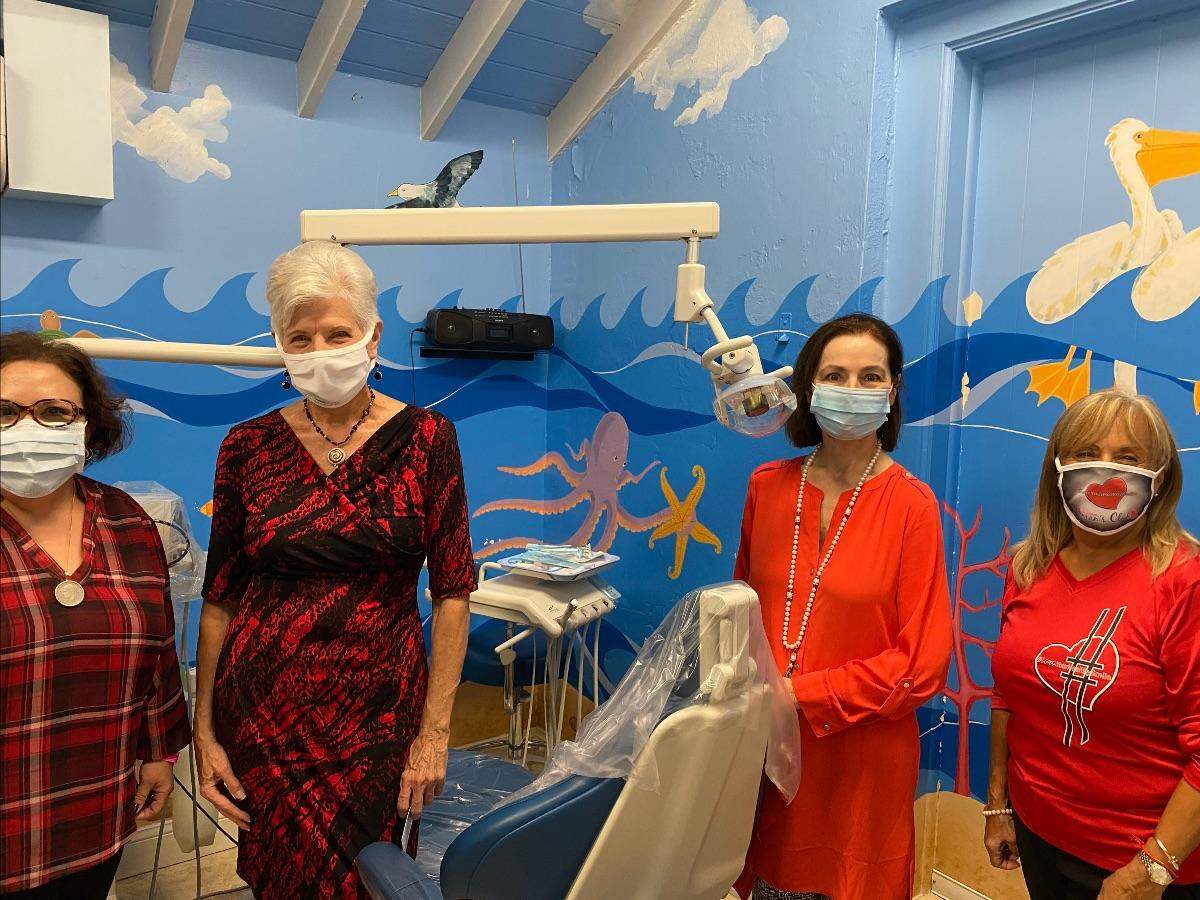 Ana Lam of the Coral Gables Woman’s Club, Beverly Loftus and Marie Vacca of The Villagers and Ruth Martinez of the Coral Gables Woman’s Club visit the Club’s Children’s Dental Clinic.