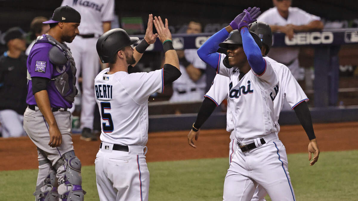 Miami Marlins shortstop Jazz Chisholm Jr. (2) is congratulated by Jon Berti (5) and Jose Devers (61)bases after hitting a three run home run during the second inning of their baseball game against the Colorado Rockies at loanDepot park on Thursday, June 10, 2021 in Miami, Florida.