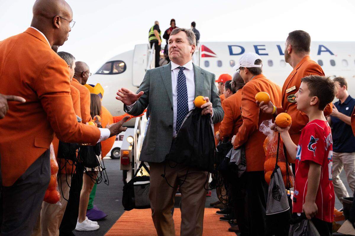 Georgia Bulldogs coach Kirby Smart is greeted after getting off the plane as his team arrived in South Florida on Tuesday, Dec. 26, 2023, for the 90th annual Capital One Orange Bowl.