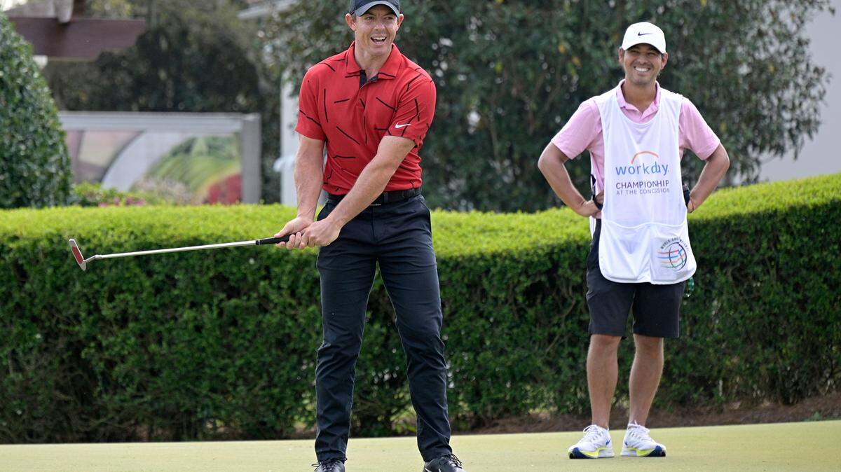 Rory McIlroy, left, of Northern Ireland, wears clothing in honor of fellow golfer Tiger Woods, while warming up on the practice green, during the final round of the Workday Championship golf tournament Sunday, Feb. 28, 2021, in Bradenton, Fla.