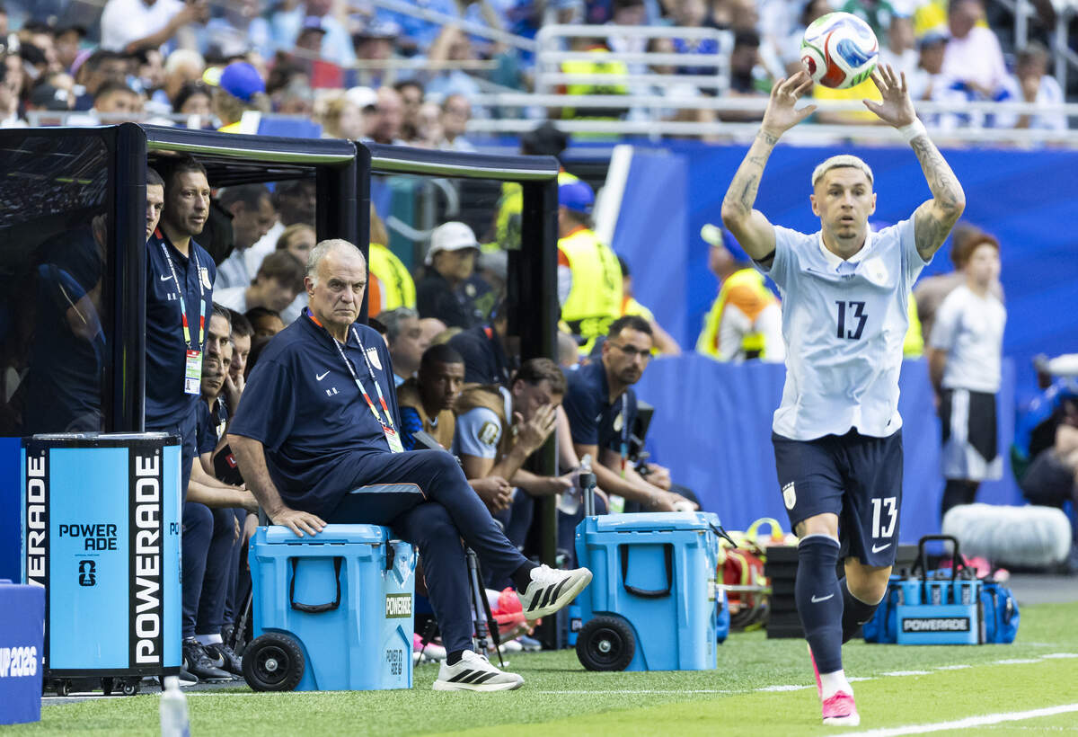 Uruguay head coach Marcelo Bielsa watches defender Guillermo Varela (13) throw in the ball against Cape Verde in the first half of their World Cup Group H soccer match at Hard Rock Stadium on Sunday, June 21, 2026, in Miami Gardens, Fla.