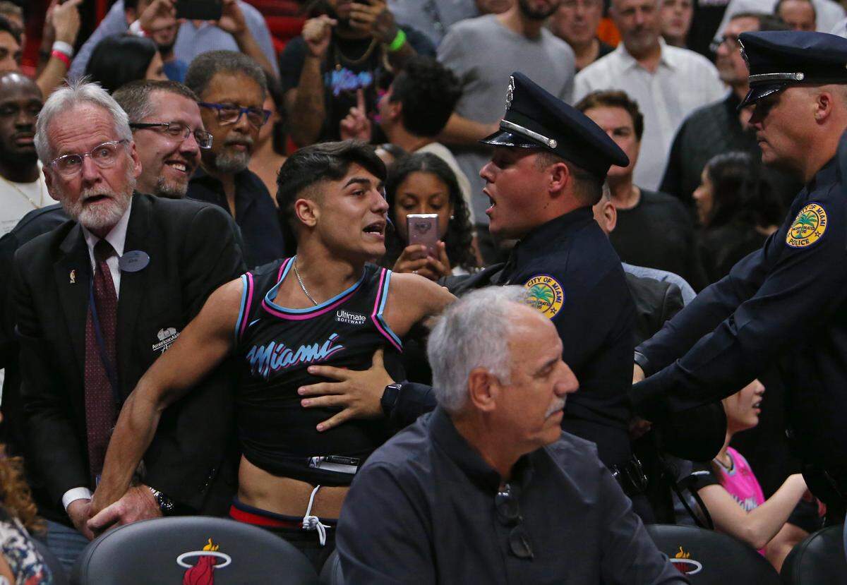 A Miami Heat fan is being arrested after rushing the court in the fourth quarter of an NBA basketball game against the Denver Nuggets at AmericanAirlines Arena on Tuesday, January 8, 2019 in Miami.