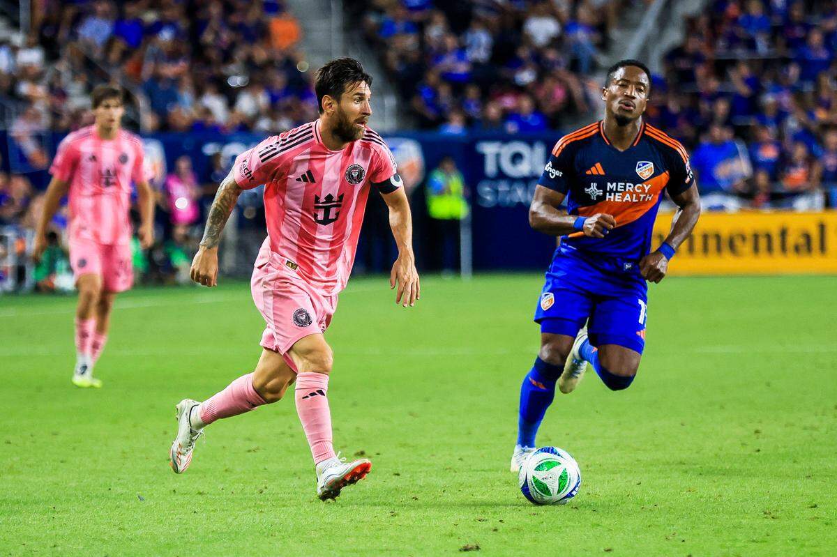 Jul 16, 2025; Cincinnati, Ohio, USA; Inter Miami CF forward Lionel Messi (10) dribbles against FC Cincinnati forward Sergio Santos (17) in the second half at TQL Stadium. Mandatory Credit: Katie Stratman-Imagn Images