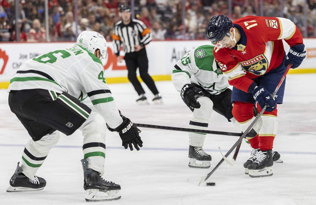 Florida Panthers center Evan Rodrigues (17) competes for the puck against Dallas Stars defenseman Ilya Lyubushkin (46) and center Colin Blackwell (15) in the first period of an NHL game at Amerant Bank Arena on Saturday, Nov. 1, 2025, in Sunrise, Fla.