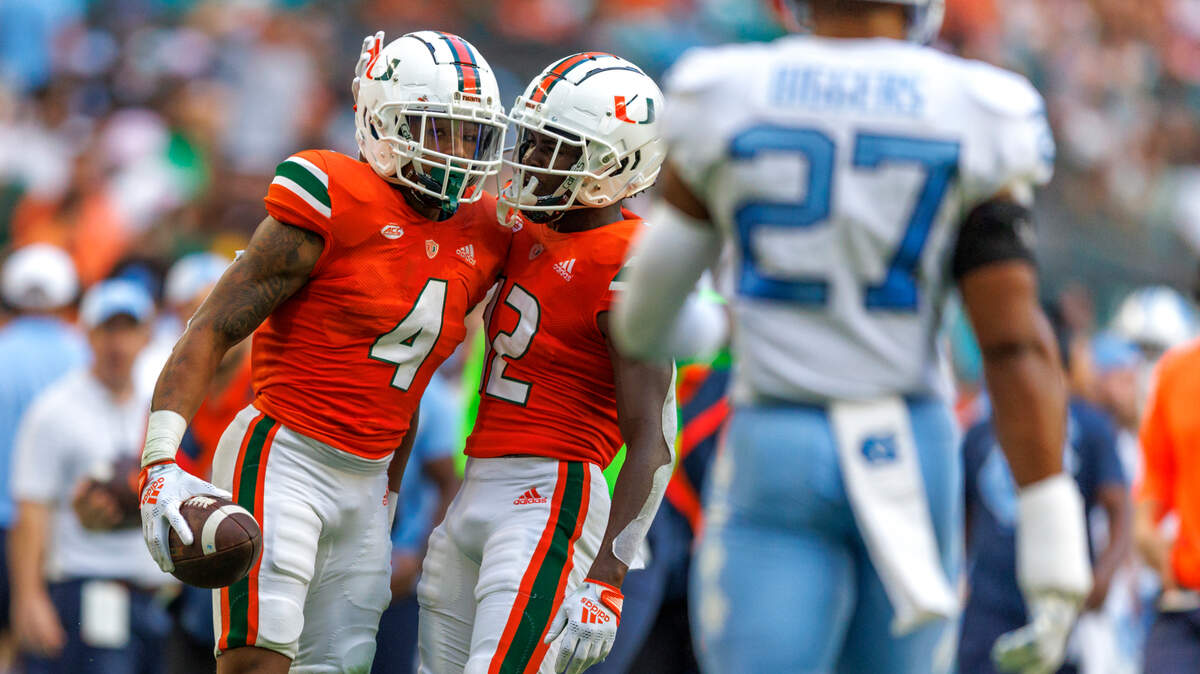 Miami Hurricanes running back Jaylan Knighton (4) is congratulated by teammate Brashard Smith (12) after a play during the second quarter of an ACC conference football game against North Carolina Tar Heels at Hard Rock Stadium on Saturday, October 8, 2022 in Miami Gardens, Florida..