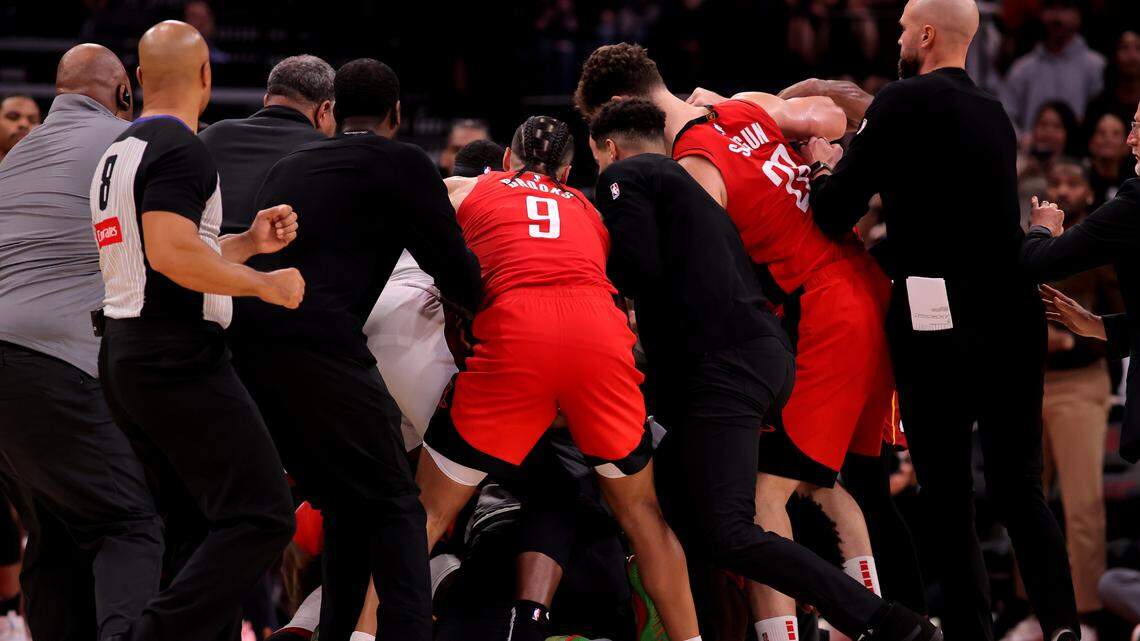 Houston Rockets and Miami Heat players break up a fight between Houston Rockets guard Amen Thompson (1) and Miami Heat guard Tyler Herro (14) during the fourth quarter at Toyota Center.