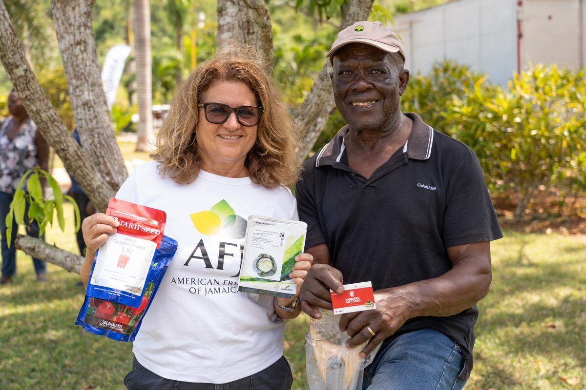 American Friends of Jamaica President Wendy Hart provides a farmer in Trelawny with a gift card to help in rebuild after Hurricane Melissa devastated western Jamaica on Oct. 28, 2025.