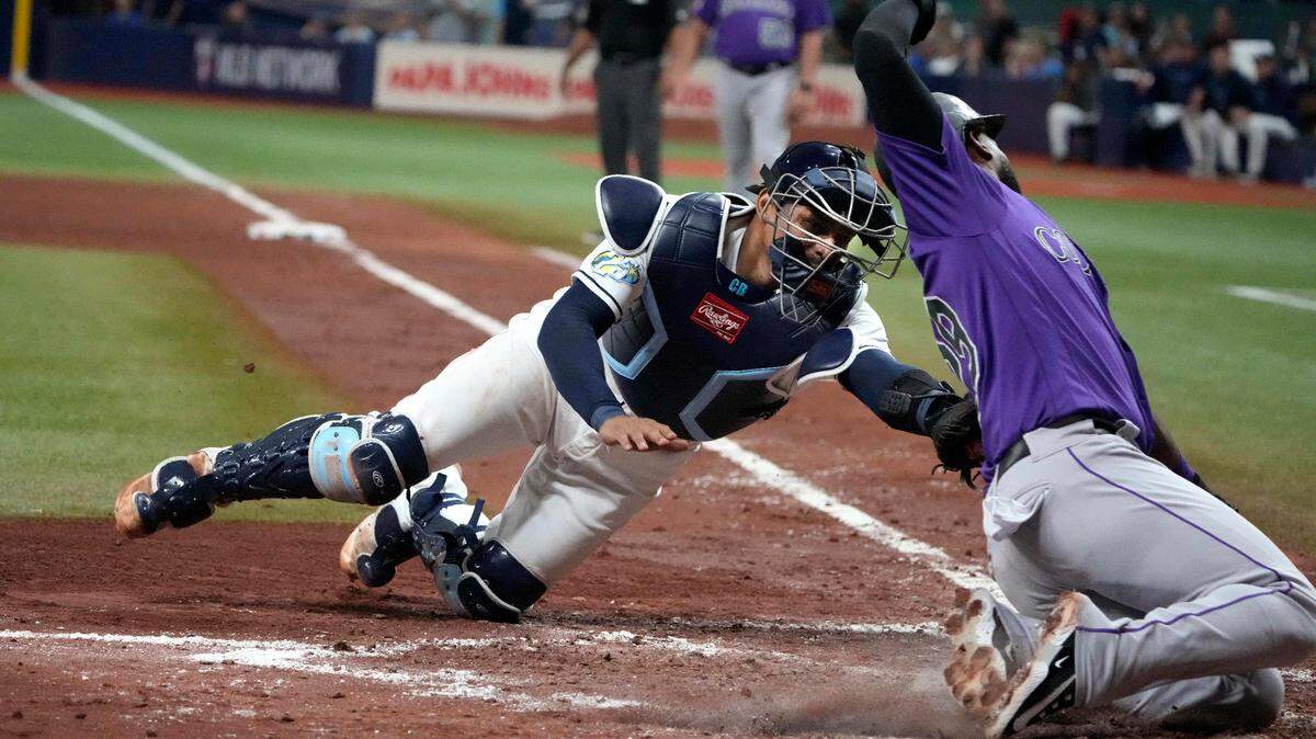 Aug 23, 2023; St. Petersburg, Florida, USA; Tampa Bay Rays catcher Christian Bethancourt (14) tags out Colorado Rockies left fielder Jurickson Profar (29) at home plate during the sixth inning at Tropicana Field.