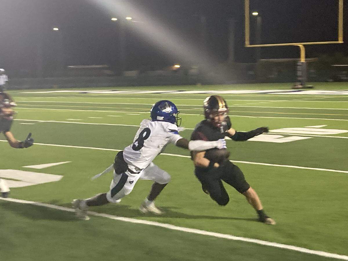 South Dade cornerback Martavious Jean-Baptiste (8) attempts to bring down Goleman receiver Adrian Atoa who finished the night with 9 catches for 162 yards and two touchdowns in a Region 4-7A football quarterfinal on Saturday at Traz Powell Stadium.