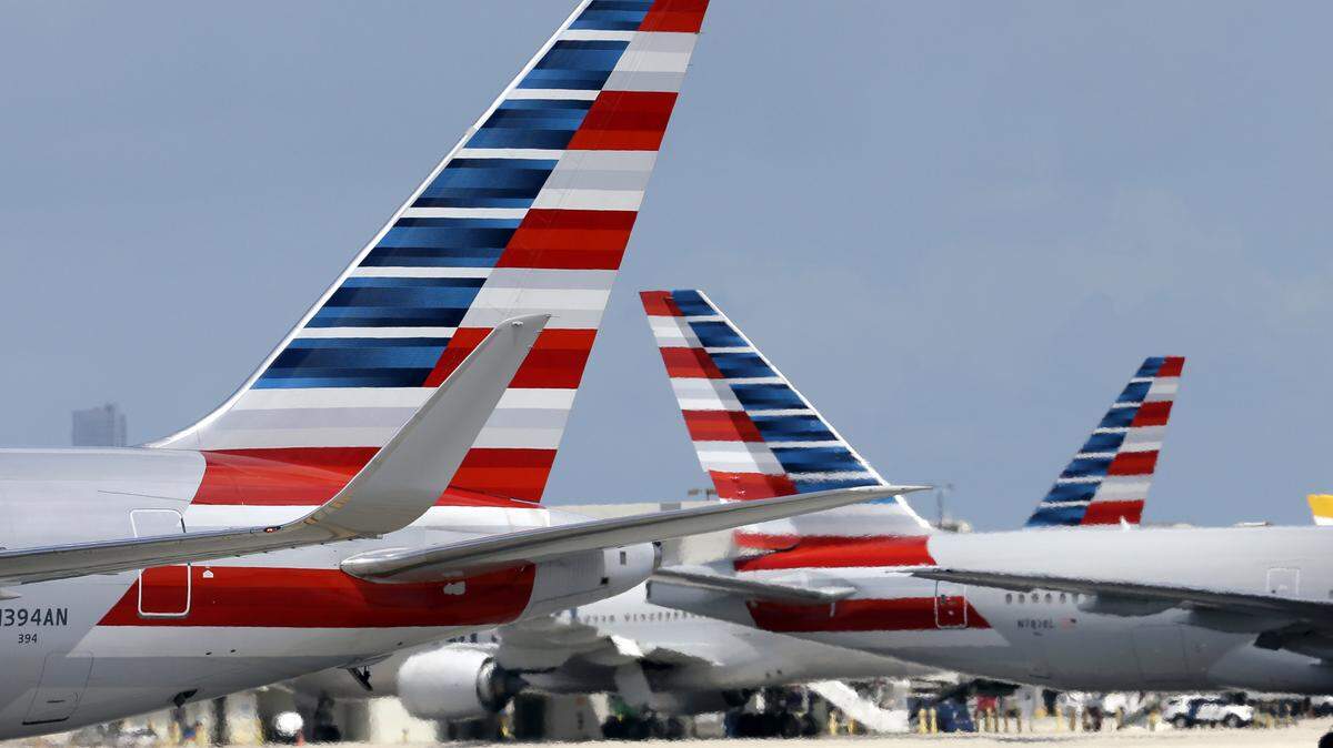 American Airlines jets taxi at Miami International Airport, in Miami on May 27, 2015.