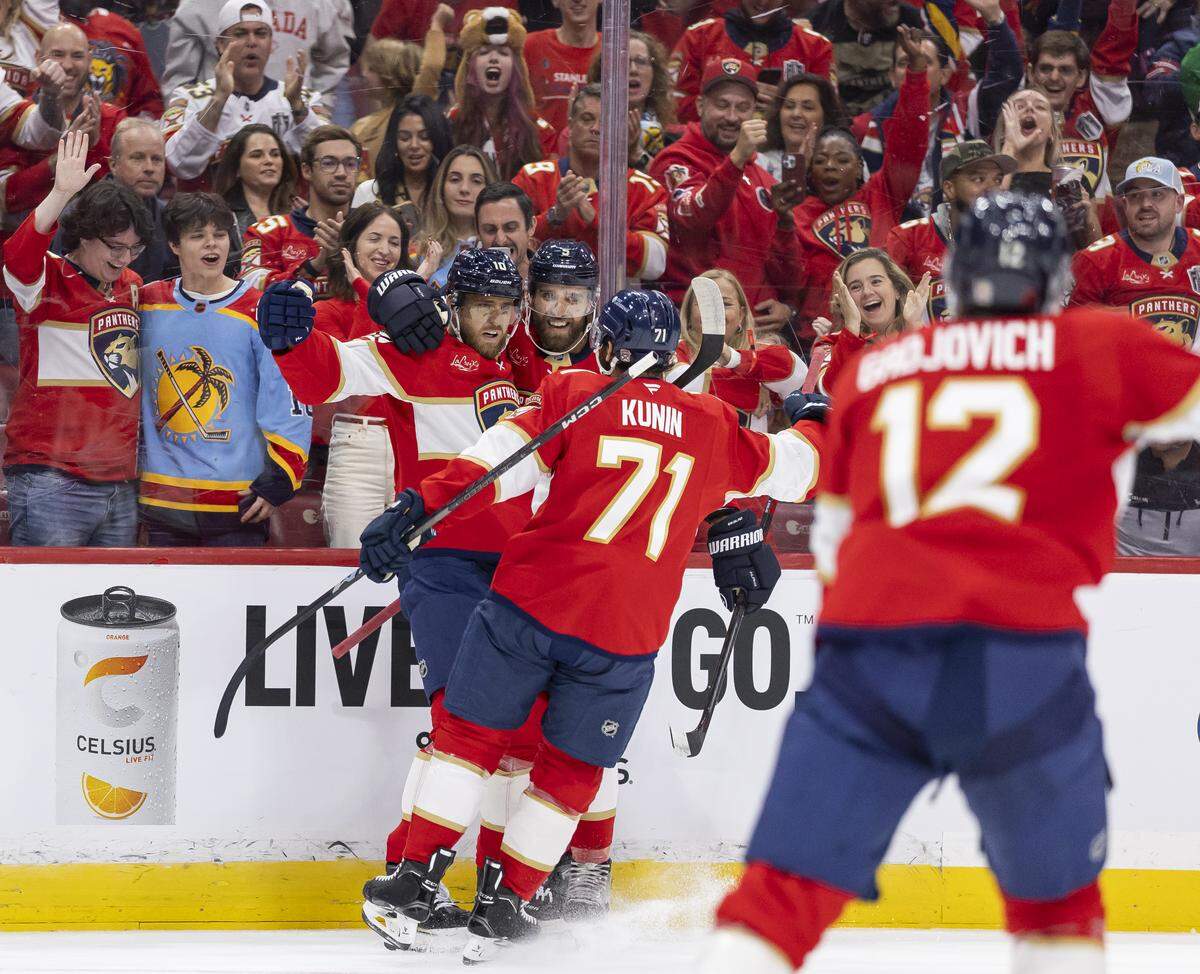 Florida Panthers left wing A.J. Greer (10) celebrates with his teammates after scoring against Chicago Blackhawks goaltender Spencer Knight (30) in the first period of their NHL game at Amerant Bank Arena on Tuesday, Oct. 7, 2025, in Sunrise, Fla.