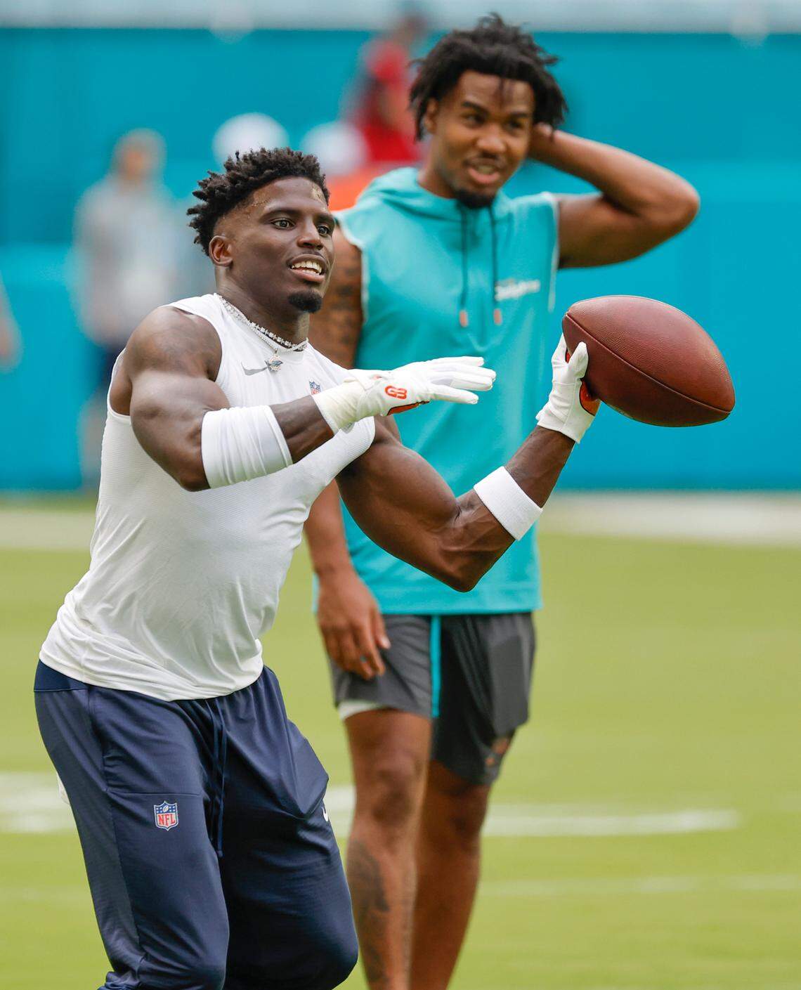 Miami Dolphins wide receiver Tyreek Hill (10) throws the ball during warmups before the game against the Washington Commanders at Hard Rock Stadium in Miami Gardens, Florida on Saturday, August 17, 2024.