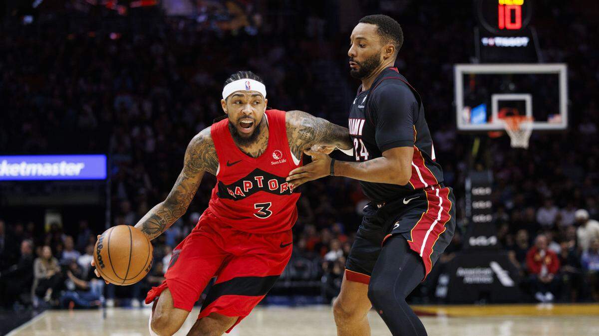 Toronto Raptors forward Brandon Ingram (3) drives past Miami Heat guard Norman Powell (24) during the first half of a game on Dec. 15, 2025, at Kaseya Center in Miami.