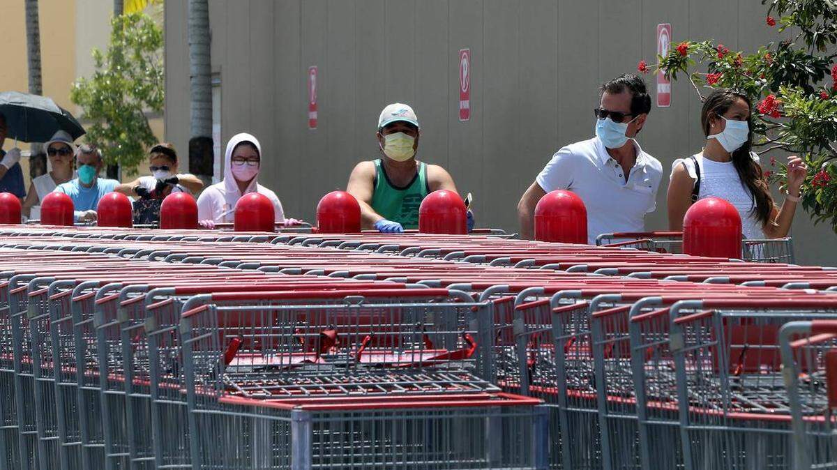Shoppers wearing masks line up to enter a Costco at Flagler Street and Southwest 79th Avenue in Miami-Dade County.