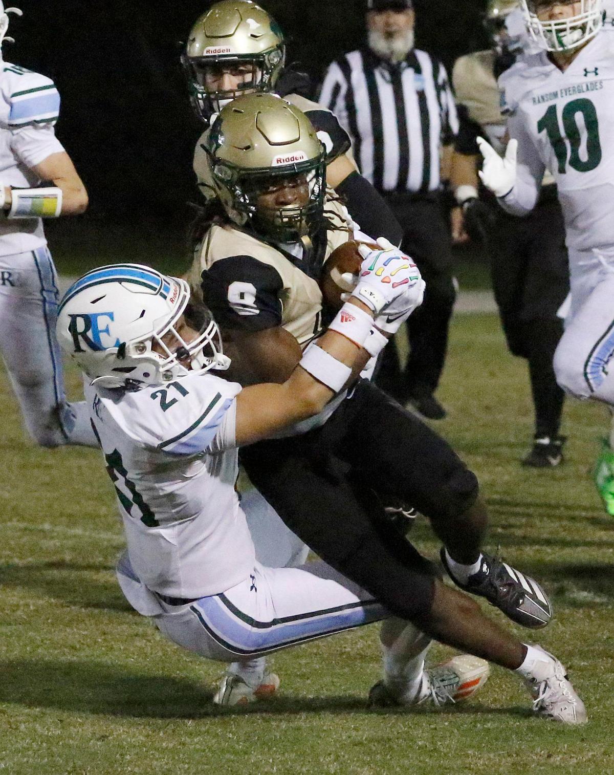 Immaculata-La Salle Royal Lions wide receiver Terrance Smith Jr (8) is sacked by Ransom Everglades Raiders Hans Van de Kreeke (21) during the football game on Thursday, November 7, 2024 at Immaculata-La Salle HS in Miami. Andrew Uloza / for Miami Herald