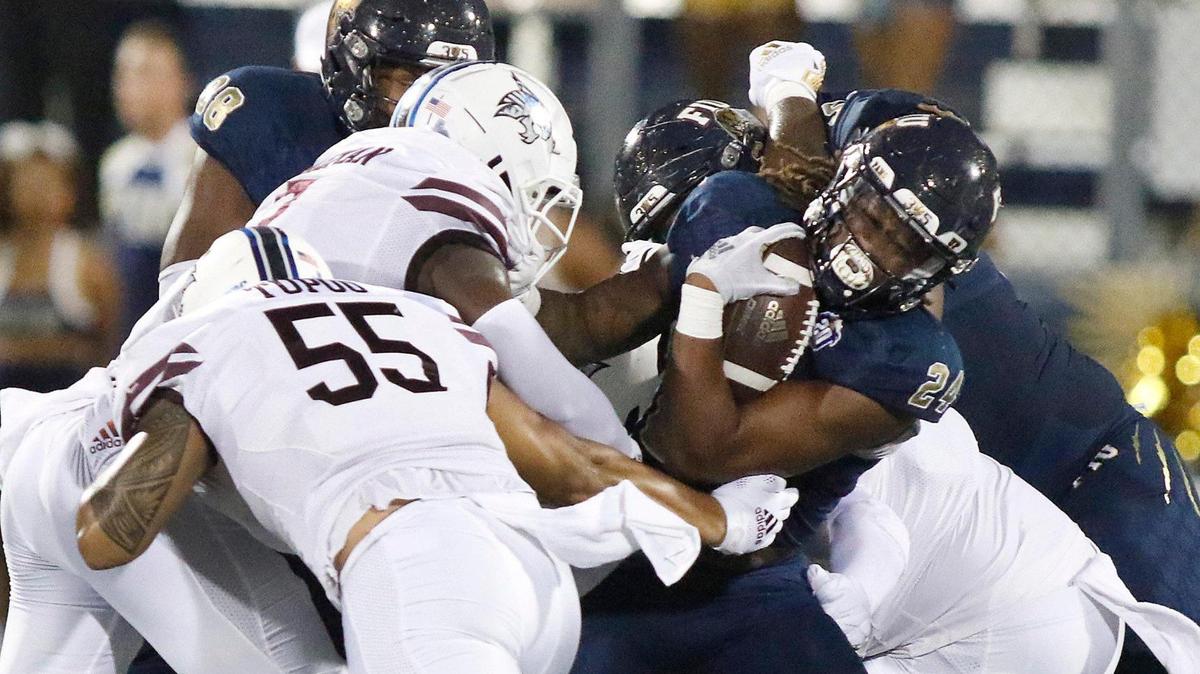FIU running back D’vonte Price (24) attempts to break free from Texas State defenders during the football game on Saturday, September 11, 2021 at Riccardo Silva stadium in Miami
