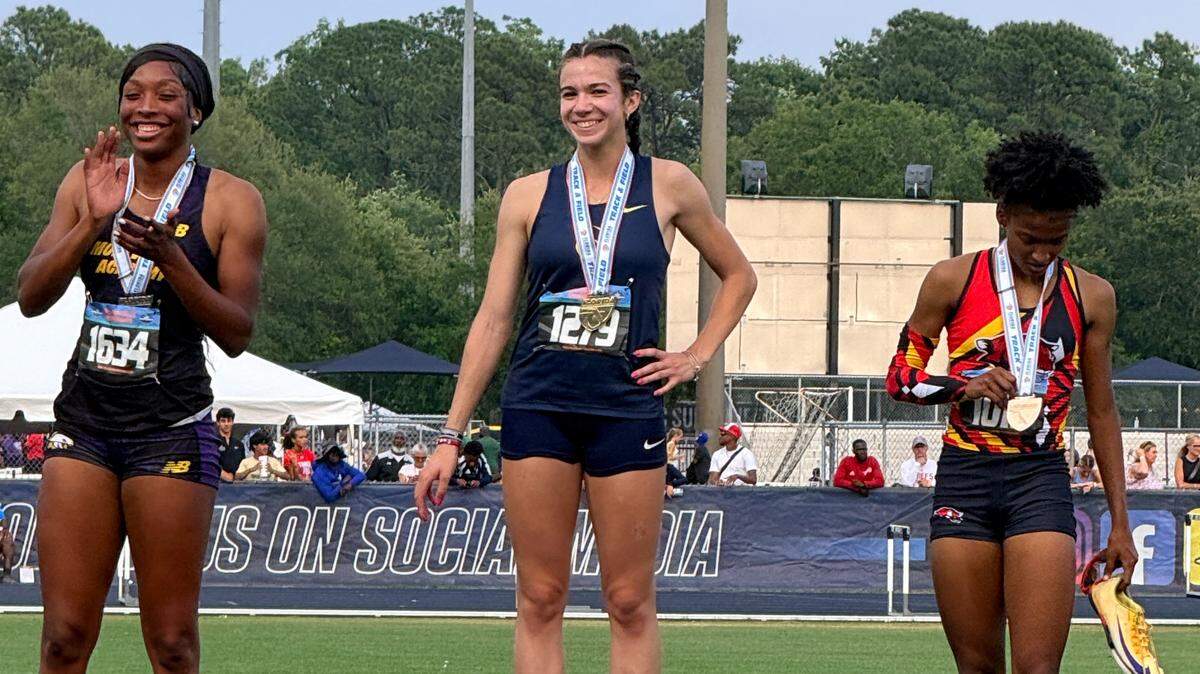 Carrollton’s Arianna Garcia (middle) stands on the podium after one of her state championship victories in the hurdles on Thursday at the state Class 2A track and field championships at UNF in Jacksonville, Fla.