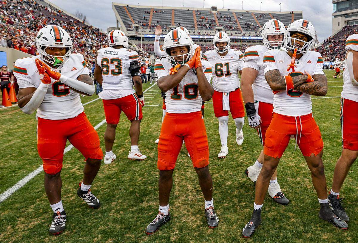Miami Hurricanes running back Charmar Brown (6) wide receiver Malachi Toney (10) and wide receiver Keelan Marion (0) ceelbrate in the endzone after Toney scores to seal the game against the Virginia Tech Hokies late in the second half at Lane Stadium in Blacksburg, Virginia, on Saturday, November 22, 2025.