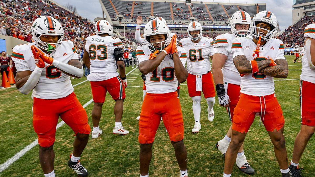 Miami Hurricanes running back Charmar Brown (6) wide receiver Malachi Toney (10) and wide receiver Keelan Marion (0) ceelbrate in the endzone after Toney scores to seal the game against the Virginia Tech Hokies late in the second half at Lane Stadium in Blacksburg, Virginia, on Saturday, November 22, 2025.