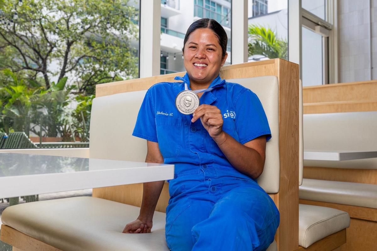Chef Valerie Chang strikes a pose with her James Beard Award at Maty’s restaurant in Midtown Miami.