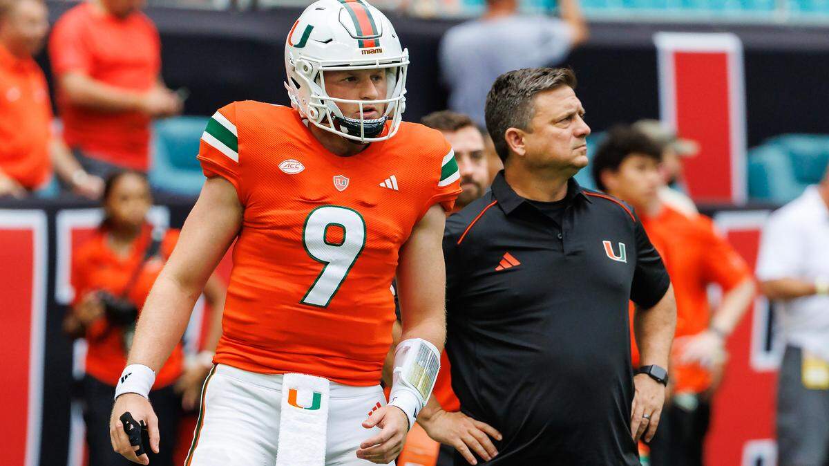Miami Hurricanes Offensive Coordinator / Quarterbacks Coach Shannon Dawson works with Hurricanes quarterback Tyler Van Dyke (9) before the start of the their NCAA non conference game against Texas A&M at Hard Rock Stadium on Saturday, Sept. 9, 2023 in Miami Gardens, Florida.
