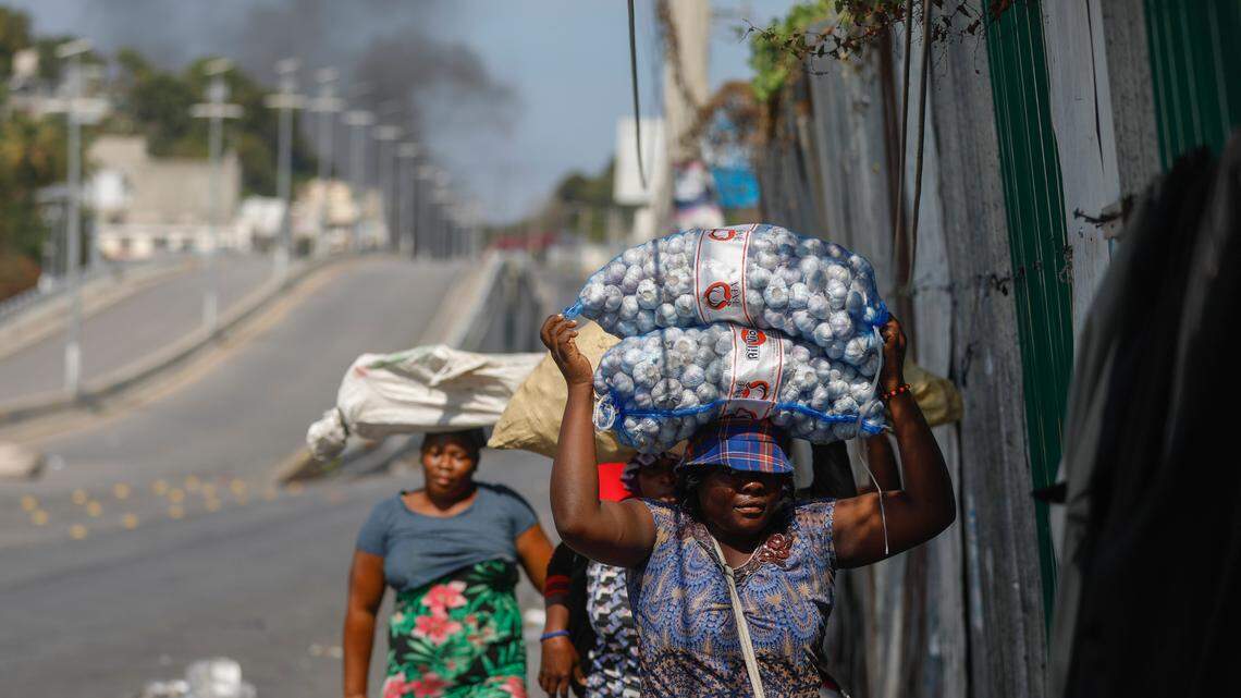 Street vendors run during clashes between police and gangs in Port-au-Prince, Haiti, Wednesday, March 6, 2024. (AP Photo/Odelyn Joseph)