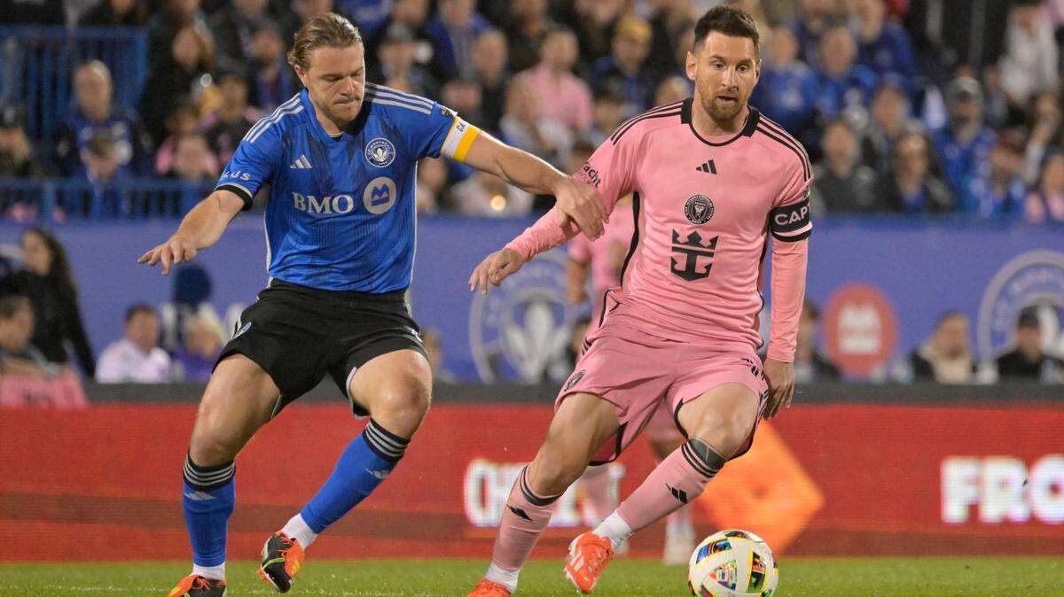 May 11, 2024; Montreal, Quebec, CAN; Inter Miami CF forward Lionel Messi (10) and CF Montreal midfielder Samuel Piette (6) battle for the ball in the second half at Stade Saputo. Mandatory Credit: Eric Bolte-USA TODAY Sports