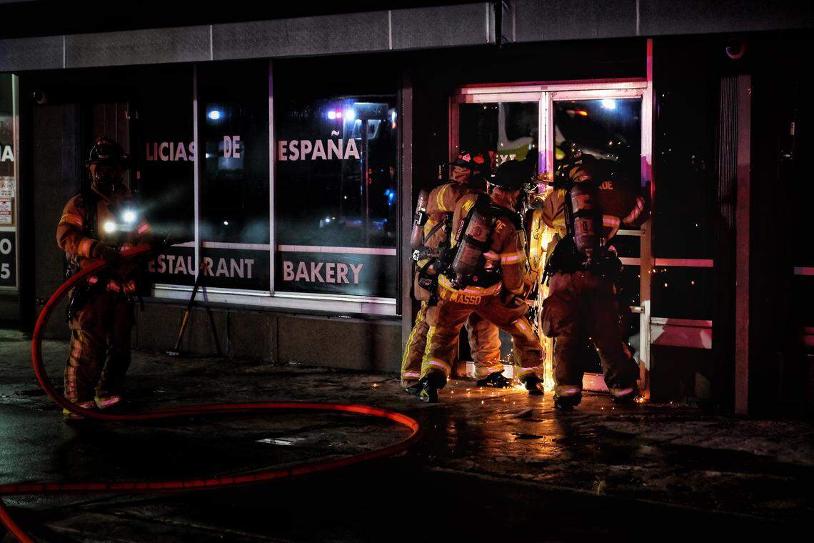 Miami-Dade firefighters try to get into Delicias de España, 4016 SW 57th Ave., early Tuesday morning, Oct. 16, 2018, to extinguish the overnight fire.