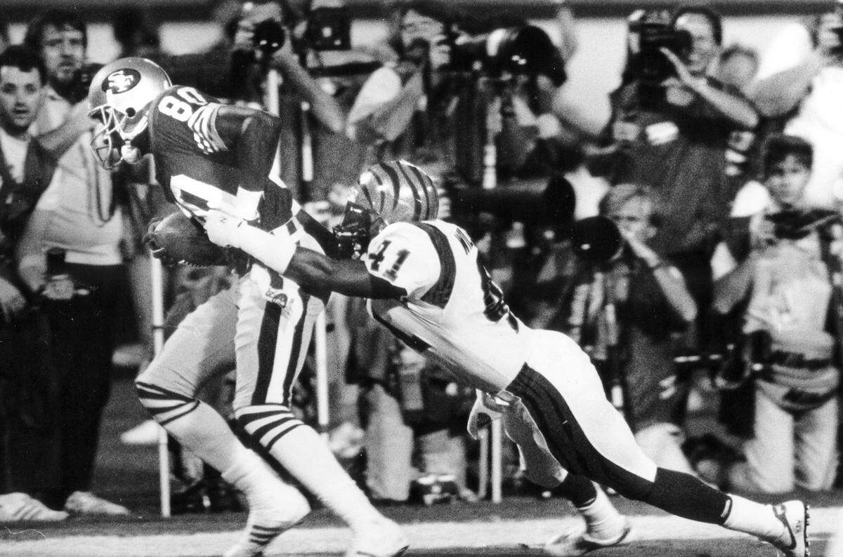 At Super Bowl XXIII in Miami on Jan. 22, 1989, Jerry RIce tries to get away from the Cincinnati Bengals defense.