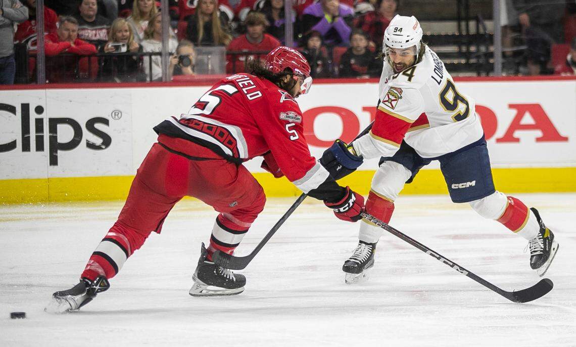 The Florida Panthers Ryan Lomberg (94) fires a shot on Carolina Hurricanes Jalen Chatfield (5) in overtime, that was nullified due to goalie interference during Game 1 of the Eastern Conference Finals on Thursday, May 18, 2023 at PNC Arena in Raleigh, N. C.