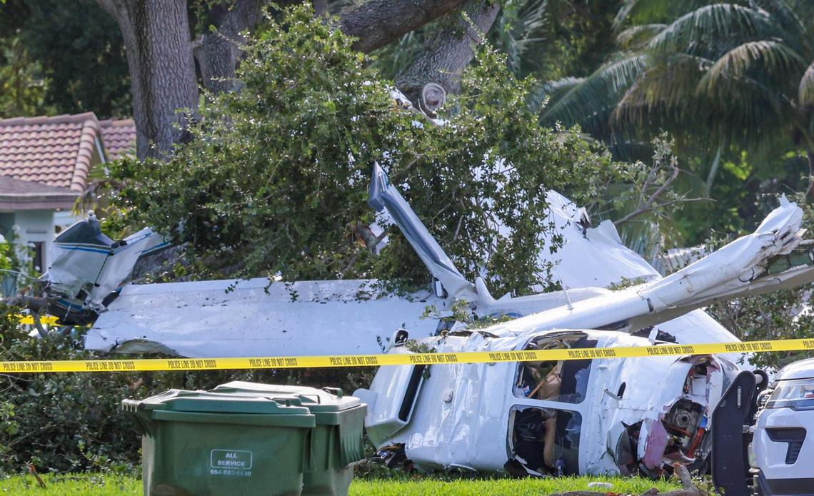 Debris is scattered across the front lawn after a plane crashed in a residential community in Pembroke Pines on Sunday night, July 13, 2025, injuring the four people on the plane. The aircraft was preparing to land at North Perry Airport in Pembroke Pines when the crash occurred.