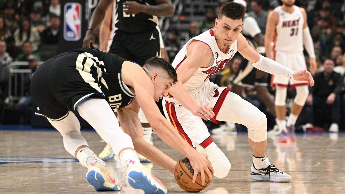 Miami Heat guard Tyler Herro (14) injures his hand while diving for a loose ball against the Milwaukee Bucks during game one of the 2023 NBA Playoffs at Fiserv Forum.