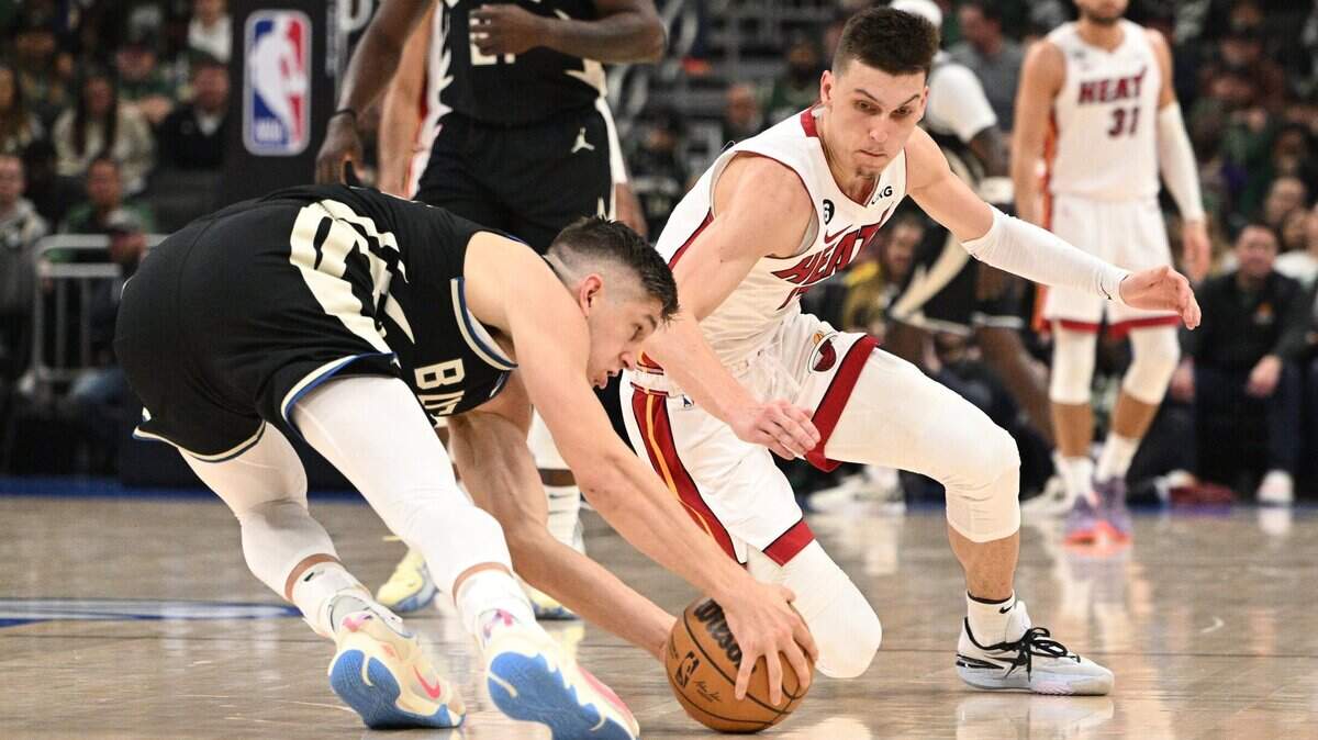 Miami Heat guard Tyler Herro (14) injures his hand while diving for a loose ball against the Milwaukee Bucks during game one of the 2023 NBA Playoffs at Fiserv Forum.