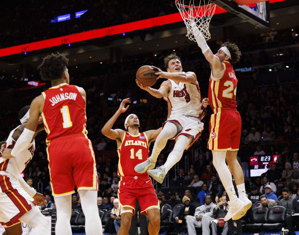 Miami Heat guard Pelle Larsson (9) tries to shoot over Atlanta Hawks forward Corey Kispert (24) and is fouled during the first half of a game on Tuesday, Feb. 3, 2026, at the Kaseya Center in downtown Miami, Fla.  