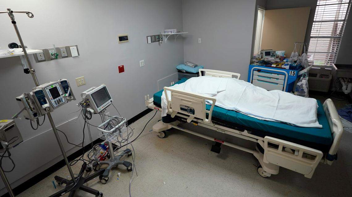 In this July 6, 2020, file photo, the body of a patient who died inside the Coronavirus Unit at United Memorial Medical Center is covered in sheets in Houston. (AP Photo/David J. Phillip, File)