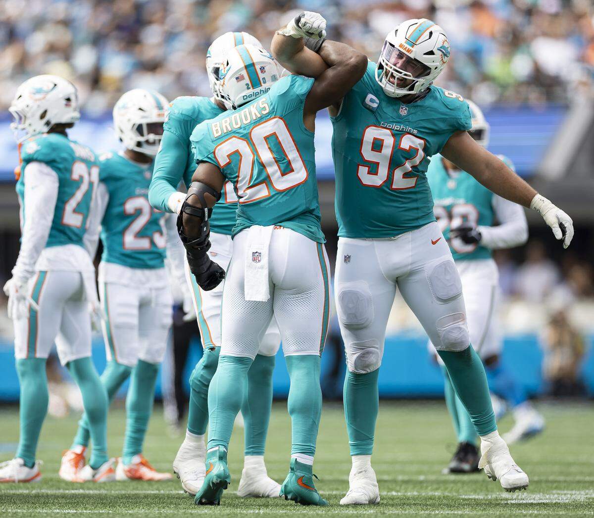 Miami Dolphins linebacker Jordyn Brooks (20) celebrates with defensive tackle Zach Sieler (92) after he tackled Carolina Panthers quarterback Bryce Young (9) in the second half of their NFL game at the Bank of America Stadium on Sunday, Oct. 5, 2025, in Charlotte, N.C.