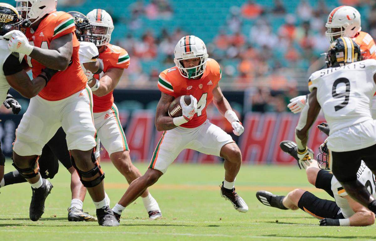 Miami Hurricanes running back Jaylan Knighton (4) runs the ball against Southern Miss Golden Eagles in the first quarter at Hard Rock Stadium in Miami Gardens on Saturday, September 10, 2022.