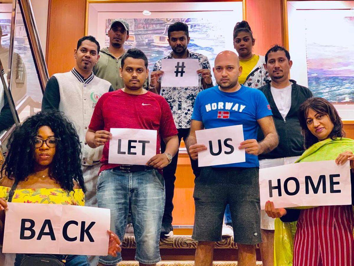 Gan Sungaralingum, 38, back row center, and his colleagues from Mauritius aboard Carnival Corporation’s Island Princess cruise ship are hoping the country will allow them to disembark when the ship arrives in late May.